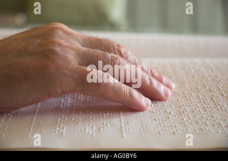 Person`s hand reading book in braille close up Stock Photo